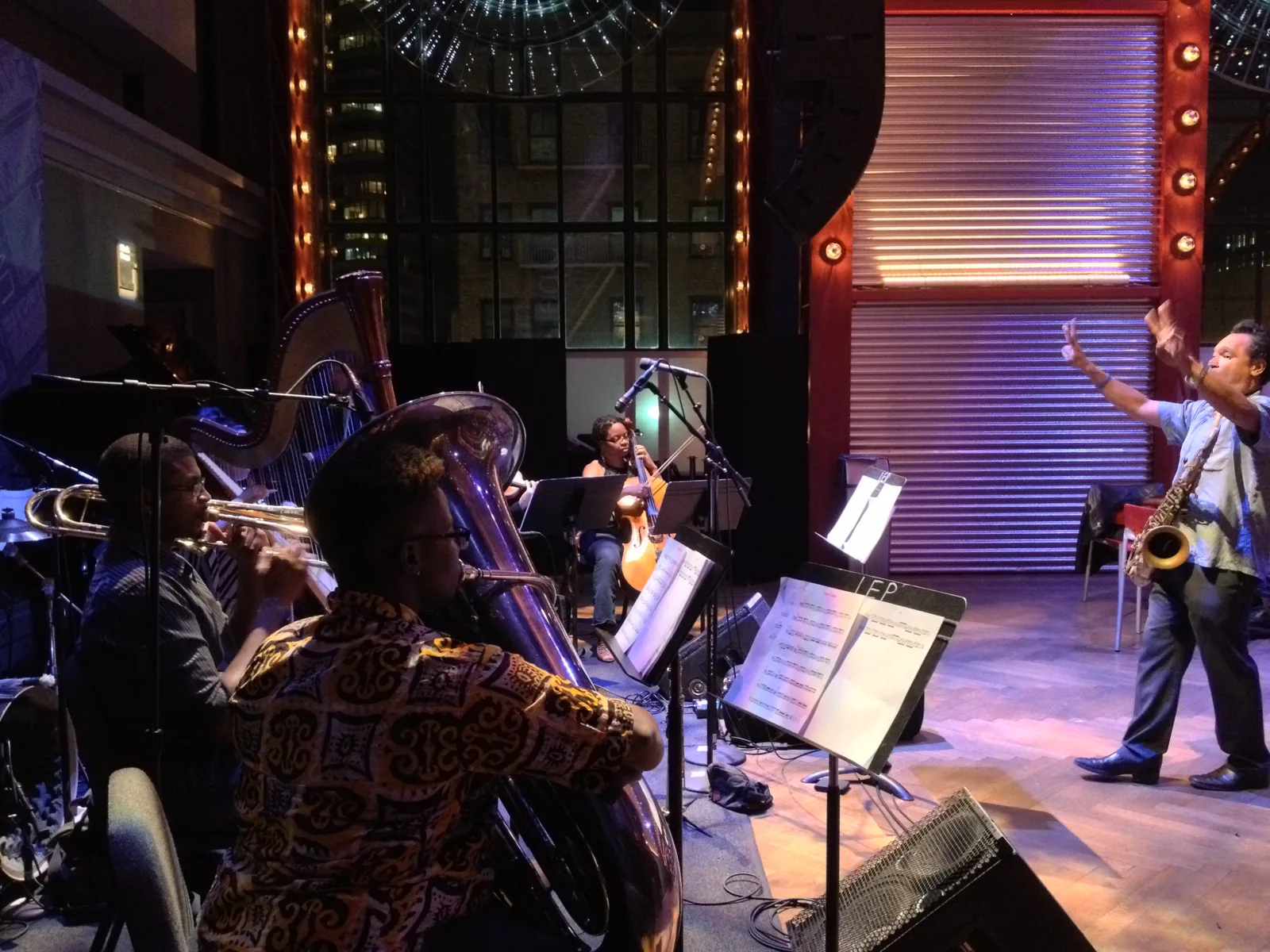Jay Rodriguez Sierra conducting a new work with brass, harp and strings at BAM Caf&eacute;.