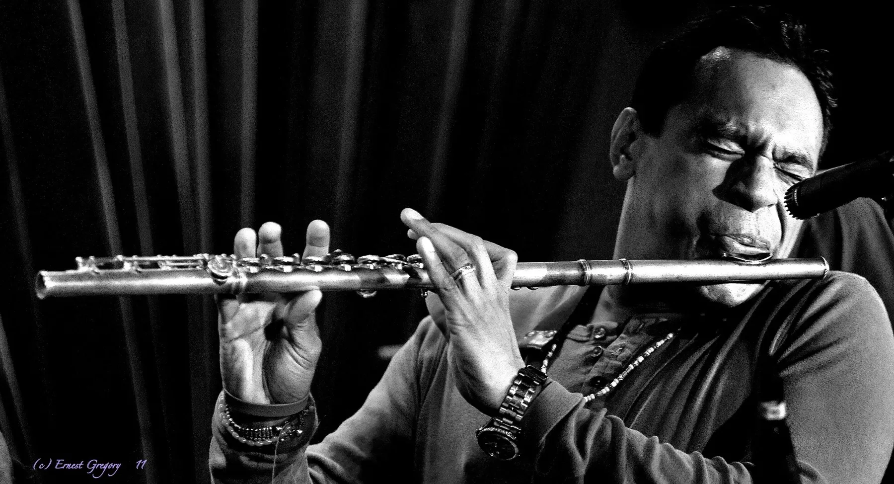 Black-and-white photo of Jay Rodriguez Sierra playing flute.