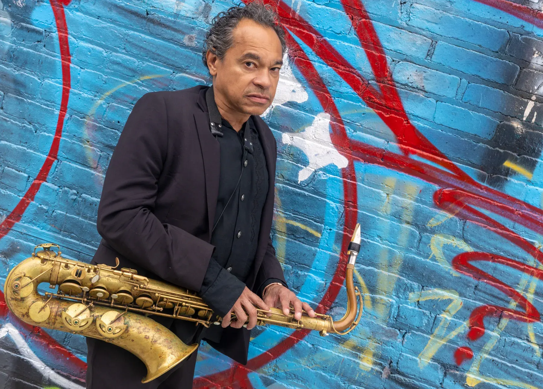 With saxophone, graffiti wall